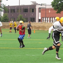 Datrell Thompson prepares to throw a pass during drills as East High School Football returns to Breese Stevens Field, absent since 1975, with a scrimmage on August 8, 2015.