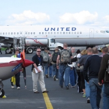 A group of U.S. Servicemen and women head off to a training exercise aboard a charter flown by United Airlines.