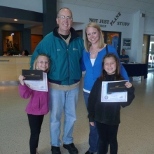 Young Eagle Pilot Bob Gilreath with Gabrielle Masten (left) and Morgan Masten (right) along with their  mother Jennie. Each Young Eagle receives a certificate, logbook, and free online ground school. Courtesy: Jennie Masten