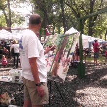A local artist interprets the scene during the Orton Park Festival, August 25, 2012.
