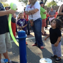 A young child can't wait for her balloon.