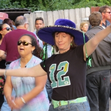 This dancer shows her Packer spirit while dancing to Madisalsa. The game was close this day and the band leader periodically announced the score to the crowd at the Willy Street Fair, September 14, 2014.