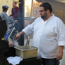 A Pig in a Fur Coat Executive Chef Dan Bonanno serving sandwiches in front of his restaurant at the Willy Street Fair, September 14, 2014.