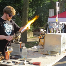 A blown glass artists shows his skills in front of Fat Pinky Glass at the Willy Street Fair, September 14, 2014.