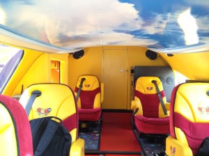 The inside of a Weinermobile, part of the bunroof can be seen above.