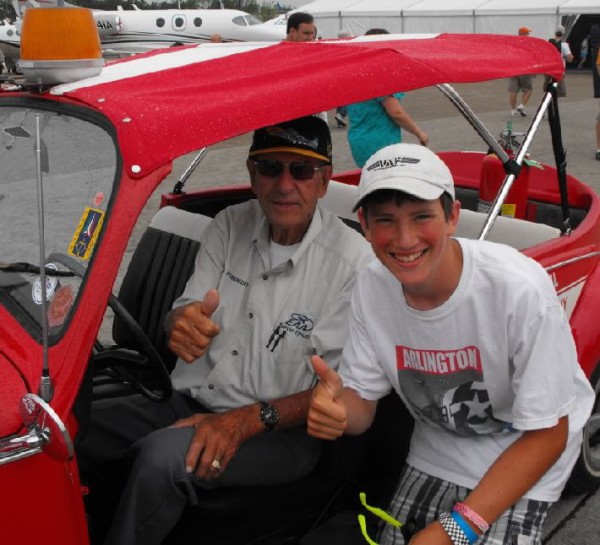 Paul Poberezny's trademarek was the "thumbs up" and countless photos of him with admirers. A fixture at the convention was Paul in his convertible VW Bug "Red One". Areas of the Oshkosh fly-in were color designated and had corresponding VW bugs. Courtesy: Vansairforce.com