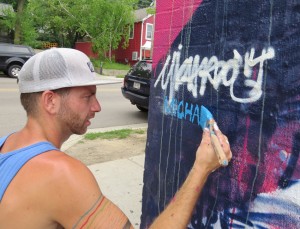Michael Owen signs his work following just over two days of painting in Madison.